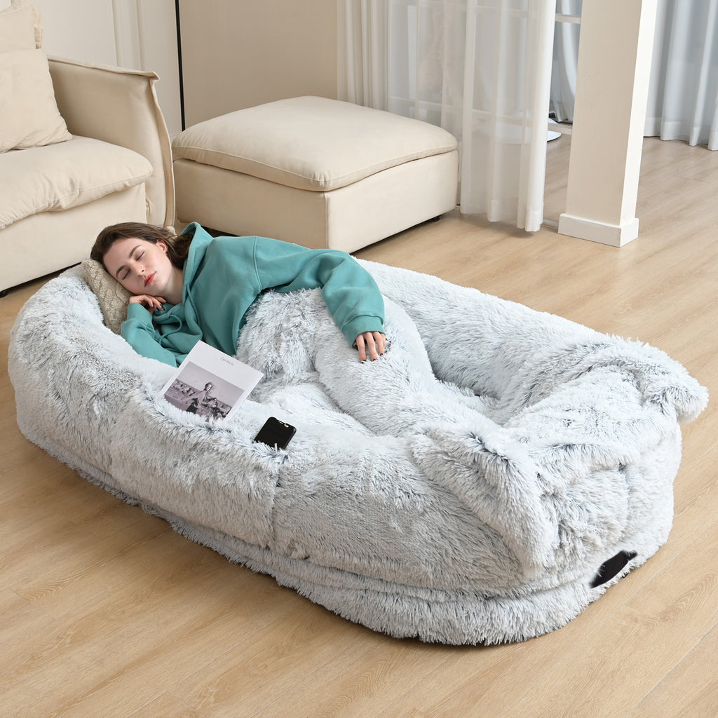 Human-size dog bed with person and dog relaxing together