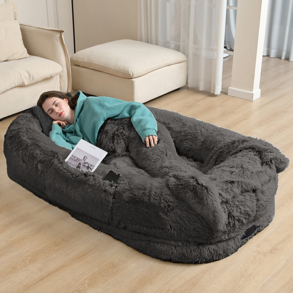 Person lounging on giant dog bed